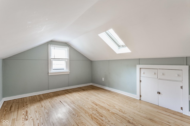 595 W Poplar St, Zionsville, IN 46077 - additional living space featuring a skylight, lofted ceiling, light wood-type flooring, and baseboards