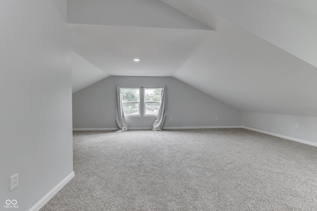 9317 E 36th Pl, Indianapolis, IN 46235 - additional living space with vaulted ceiling, carpet flooring, and baseboards