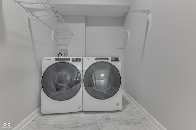9317 E 36th Pl, Indianapolis, IN 46235 - washroom with marble look tiles, washer and clothes dryer, and baseboards