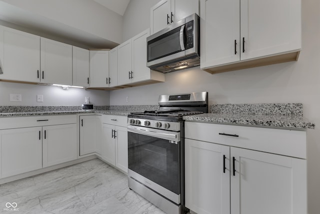 9317 E 36th Pl, Indianapolis, IN 46235 - kitchen with stainless steel appliances, light marble finish flooring, and white cabinetry