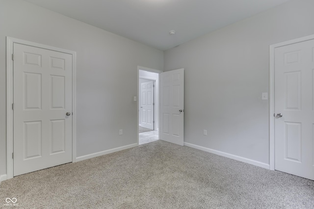 9317 E 36th Pl, Indianapolis, IN 46235 - unfurnished bedroom featuring carpet floors and baseboards