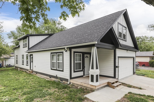 9317 E 36th Pl, Indianapolis, IN 46235 - view of front facade featuring a shingled roof, a front lawn, driveway, and covered porch
