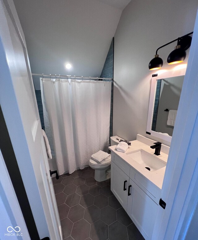 811 E Minnesota St, Indianapolis, IN 46203 - bathroom featuring vanity, toilet, tile patterned flooring, and lofted ceiling