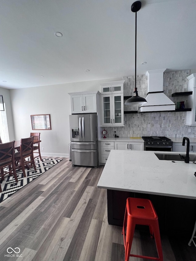 811 E Minnesota St, Indianapolis, IN 46203 - kitchen featuring stainless steel refrigerator with ice dispenser, black range with gas cooktop, custom range hood, and decorative backsplash