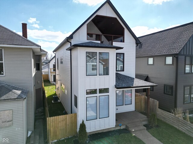 811 E Minnesota St, Indianapolis, IN 46203 - back of house featuring a shingled roof, board and batten siding, and a balcony
