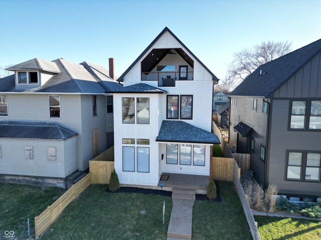 811 E Minnesota St, Indianapolis, IN 46203 - view of front facade with a balcony, board and batten siding, and a shingled roof