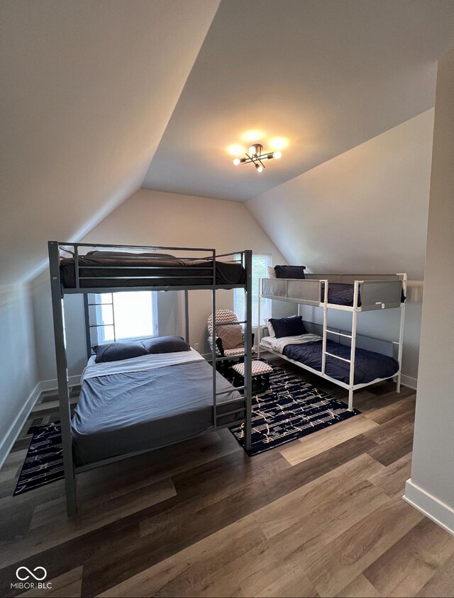 811 E Minnesota St, Indianapolis, IN 46203 - bedroom with vaulted ceiling, baseboards, and wood finished floors