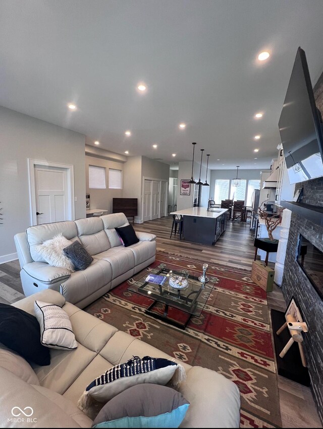 811 E Minnesota St, Indianapolis, IN 46203 - living room with dark wood-style flooring, recessed lighting, and a glass covered fireplace