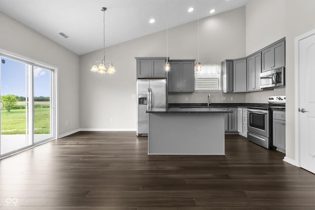 11815 Adair Pl, Indianapolis, IN 46229 - kitchen with stainless steel appliances, gray cabinetry, dark countertops, a center island, and recessed lighting