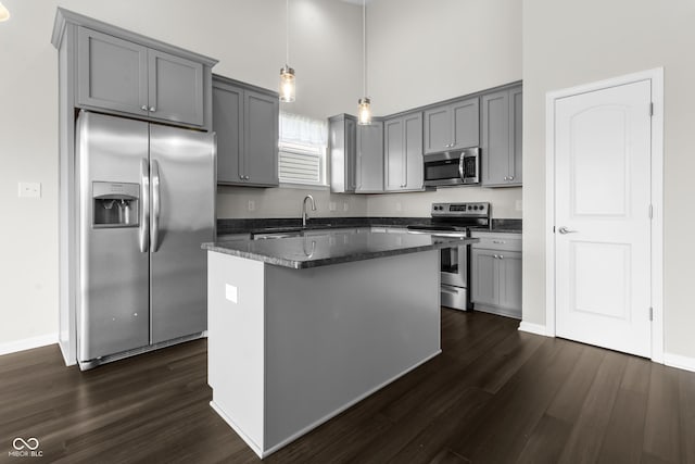 11815 Adair Pl, Indianapolis, IN 46229 - kitchen with appliances with stainless steel finishes, gray cabinets, dark wood-style floors, a kitchen island, and a towering ceiling