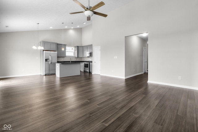 11815 Adair Pl, Indianapolis, IN 46229 - unfurnished living room with high vaulted ceiling, a ceiling fan, a sink, baseboards, and dark wood-style flooring