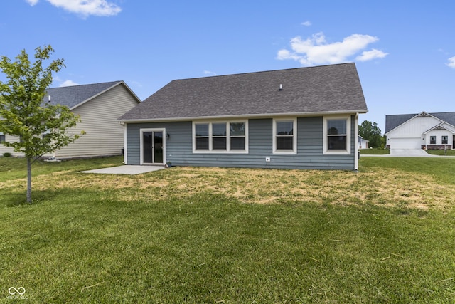 11815 Adair Pl, Indianapolis, IN 46229 - back of house with a yard, a shingled roof, and a patio