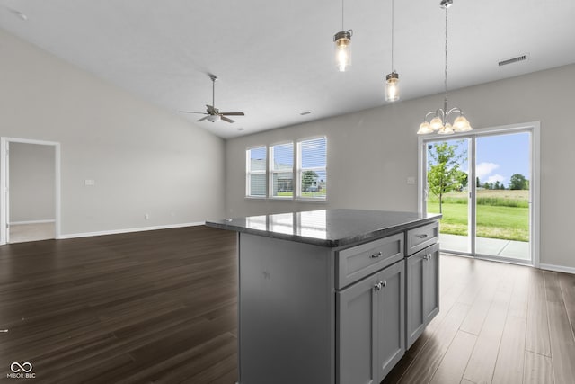11815 Adair Pl, Indianapolis, IN 46229 - kitchen with plenty of natural light, a ceiling fan, dark wood-style flooring, a kitchen island, and lofted ceiling