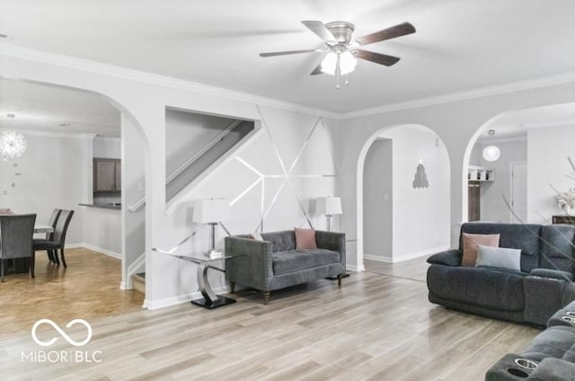 4689 Muscatine Way, Westfield, IN 46062 - living room featuring arched walkways, light wood-style floors, stairway, a ceiling fan, and crown molding