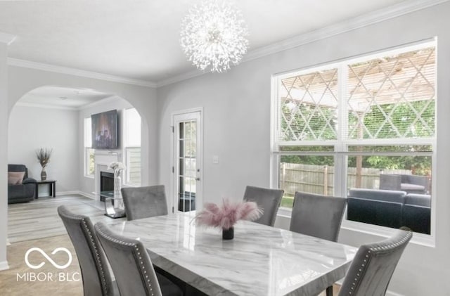 4689 Muscatine Way, Westfield, IN 46062 - dining space with arched walkways, healthy amount of natural light, a fireplace, ornamental molding, and baseboards