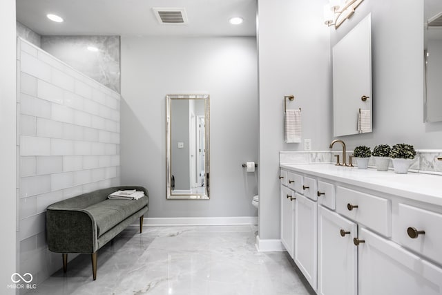 435 Virginia Ave Unit 106, Indianapolis, IN 46203 - full bath with marble tiled floors, toilet, double vanity, baseboards, and recessed lighting