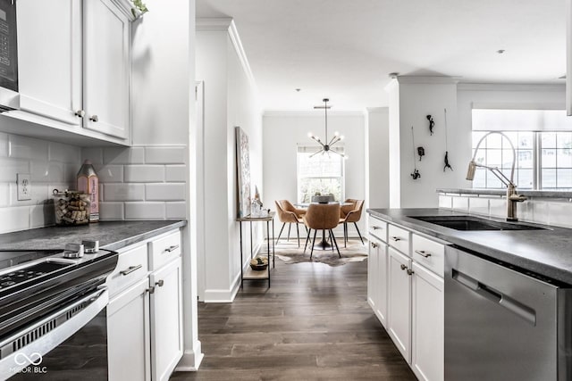 435 Virginia Ave Unit 106, Indianapolis, IN 46203 - kitchen featuring stainless steel appliances, a sink, dark countertops, tasteful backsplash, and crown molding