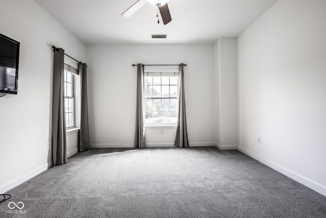 435 Virginia Ave Unit 106, Indianapolis, IN 46203 - empty room with a ceiling fan, carpet flooring, healthy amount of natural light, and baseboards