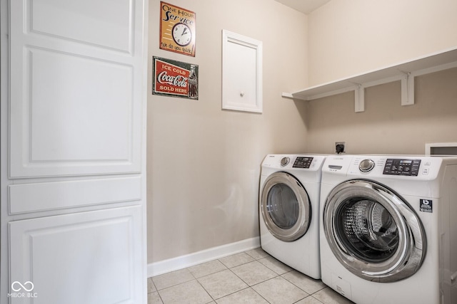 435 Virginia Ave Unit 106, Indianapolis, IN 46203 - laundry room featuring baseboards, light tile patterned flooring, and independent washer and dryer