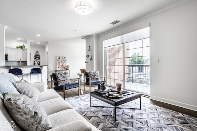 435 Virginia Ave Unit 106, Indianapolis, IN 46203 - living room featuring crown molding, wood finished floors, baseboards, and recessed lighting