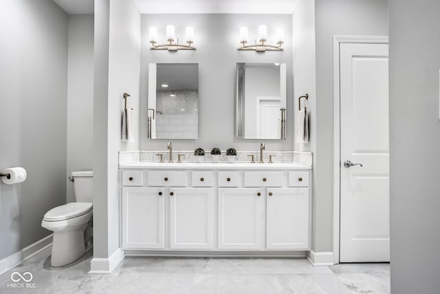 435 Virginia Ave Unit 106, Indianapolis, IN 46203 - full bath with baseboards, marble finish floors, double vanity, and toilet