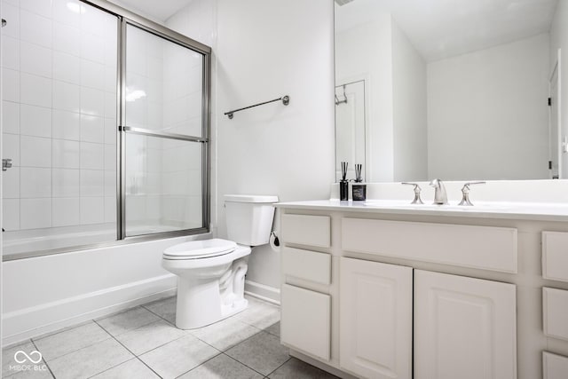 435 Virginia Ave Unit 106, Indianapolis, IN 46203 - full bath with toilet, tile patterned flooring, vanity, enclosed tub / shower combo, and baseboards