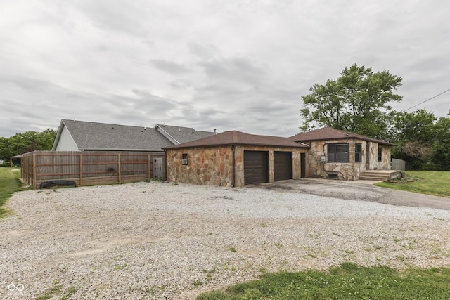 1601 Southern Ave, Beech Grove, IN 46107 - view of front of property featuring stone siding, an attached garage, and driveway