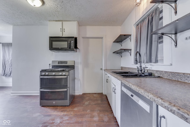 1601 Southern Ave, Beech Grove, IN 46107 - kitchen with stainless steel appliances, a sink, open shelves, a textured ceiling, and dark wood-style flooring