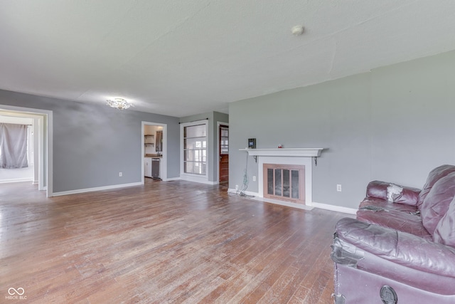 1601 Southern Ave, Beech Grove, IN 46107 - living room with wood finished floors, baseboards, and a fireplace with flush hearth