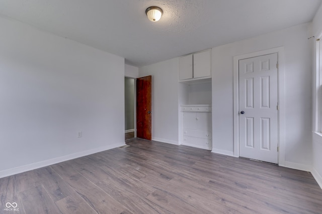 1601 Southern Ave, Beech Grove, IN 46107 - unfurnished bedroom with wood finished floors and baseboards