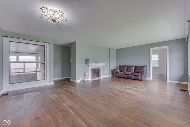 1601 Southern Ave, Beech Grove, IN 46107 - unfurnished living room featuring wood finished floors, baseboards, and a glass covered fireplace