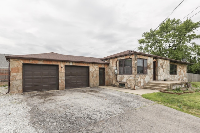 1601 Southern Ave, Beech Grove, IN 46107 - view of front of property with stone siding, driveway, a garage, and roof with shingles