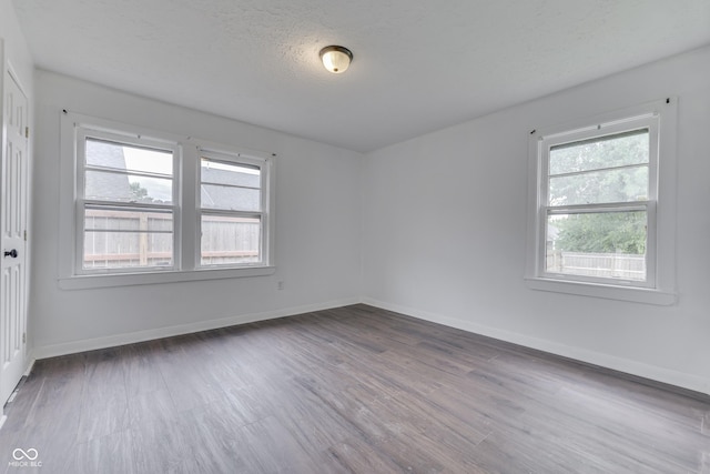 1601 Southern Ave, Beech Grove, IN 46107 - spare room with wood finished floors, baseboards, and a textured ceiling