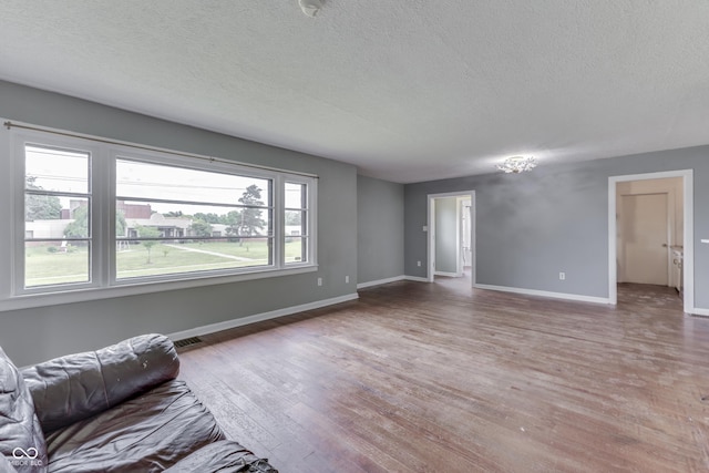 1601 Southern Ave, Beech Grove, IN 46107 - living area with wood finished floors, a textured ceiling, and baseboards