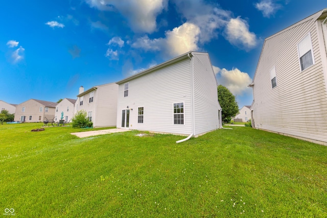 4056 Orchard Valley Ln, Indianapolis, IN 46235 - back of property with a yard, a residential view, and a patio area