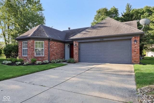 7061 Woodgate Cir, Fishers, IN 46038 - view of front facade with brick siding, concrete driveway, a garage, and a front lawn