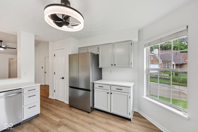 7061 Woodgate Cir, Fishers, IN 46038 - kitchen featuring appliances with stainless steel finishes, ceiling fan, light countertops, and light wood finished floors
