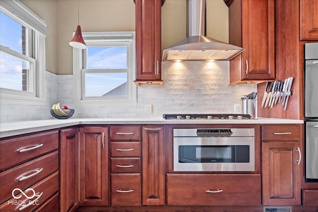 14711 Macduff Dr, Noblesville, IN 46062 - kitchen with wall chimney range hood, stainless steel gas stovetop, plenty of natural light, and light countertops
