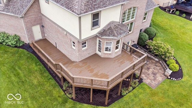 14711 Macduff Dr, Noblesville, IN 46062 - rear view of property with a deck, brick siding, a yard, and a shingled roof