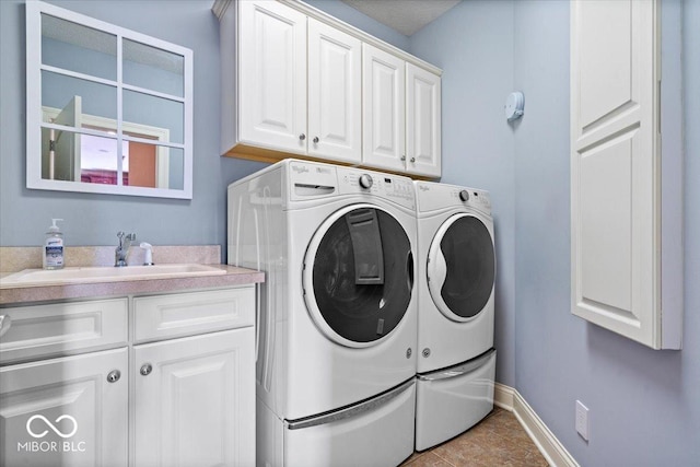 14711 Macduff Dr, Noblesville, IN 46062 - laundry area with cabinet space, washer and dryer, baseboards, and tile patterned floors