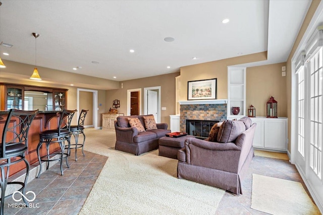 14711 Macduff Dr, Noblesville, IN 46062 - carpeted living room with a glass covered fireplace, healthy amount of natural light, baseboards, and recessed lighting
