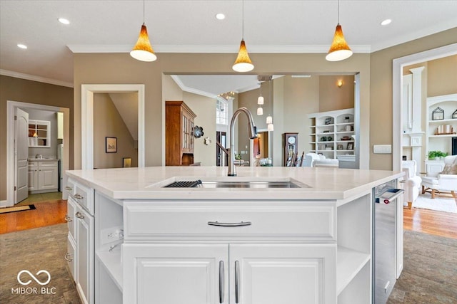 14711 Macduff Dr, Noblesville, IN 46062 - kitchen featuring a sink, light wood-style flooring, white cabinetry, hanging light fixtures, and ornamental molding