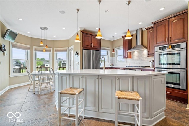 14711 Macduff Dr, Noblesville, IN 46062 - kitchen featuring stainless steel appliances, a sink, wall chimney range hood, light countertops, and tasteful backsplash