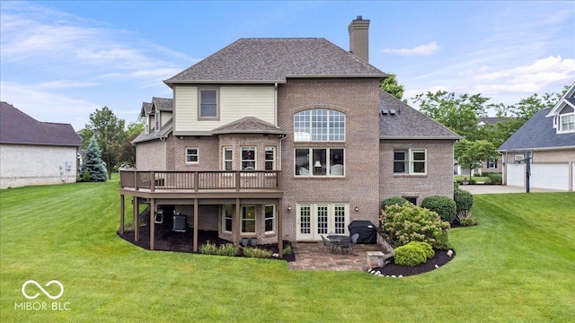 14711 Macduff Dr, Noblesville, IN 46062 - rear view of house featuring a chimney, a lawn, brick siding, and a deck