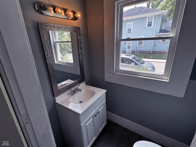 3502 N Kenwood Ave, Indianapolis, IN 46208 - bathroom featuring vanity, baseboards, toilet, and wood finished floors