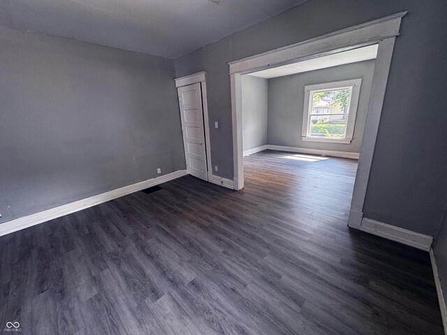 3502 N Kenwood Ave, Indianapolis, IN 46208 - empty room with baseboards and dark wood-type flooring