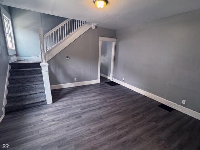 3502 N Kenwood Ave, Indianapolis, IN 46208 - unfurnished living room featuring stairway, baseboards, and wood finished floors