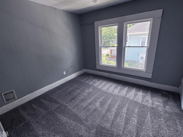 3502 N Kenwood Ave, Indianapolis, IN 46208 - empty room featuring dark colored carpet and baseboards
