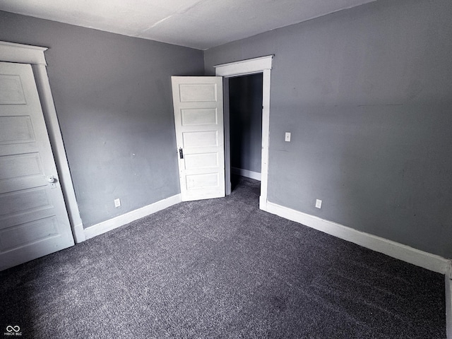 3502 N Kenwood Ave, Indianapolis, IN 46208 - unfurnished bedroom featuring dark colored carpet and baseboards