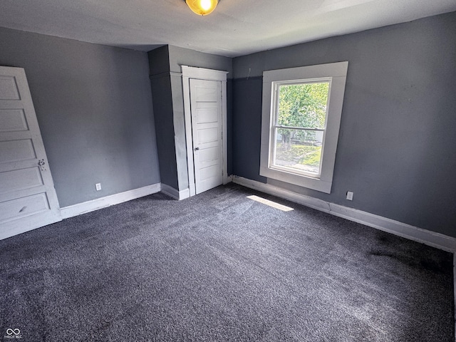 3502 N Kenwood Ave, Indianapolis, IN 46208 - unfurnished bedroom featuring dark colored carpet and baseboards